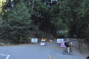 A biker on Wildcat Canyon Rd. stops outside the barriers employed to control the activity in areas of fire risk.