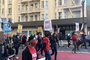 Members of the PSL, along with others, march down Powell Street in San Francisco at a protest against detention camps.