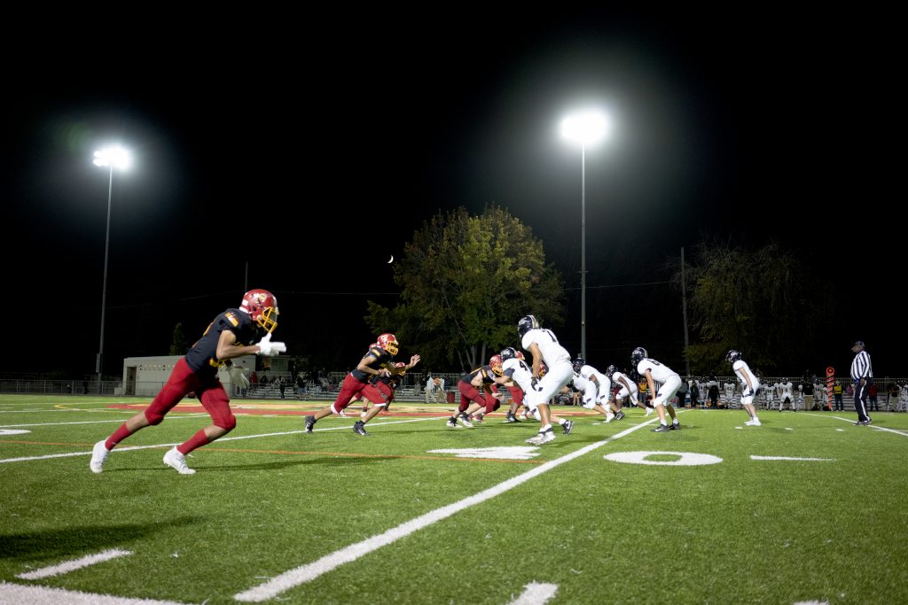 The Berkeley High School varsity football team plays under the stadium lights during Friday night’s home game. 
