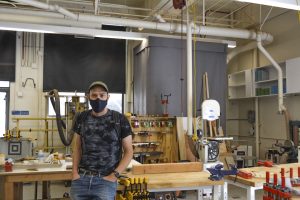 Dirk Wright, the founder of BHS’ new skateboard workshop, sits in the woodshop. 