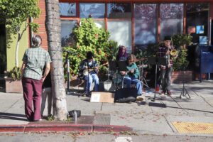Elliott Martens, Myles Blazer, Nicolas Hernandez, and Calder Underwood perform on the street.