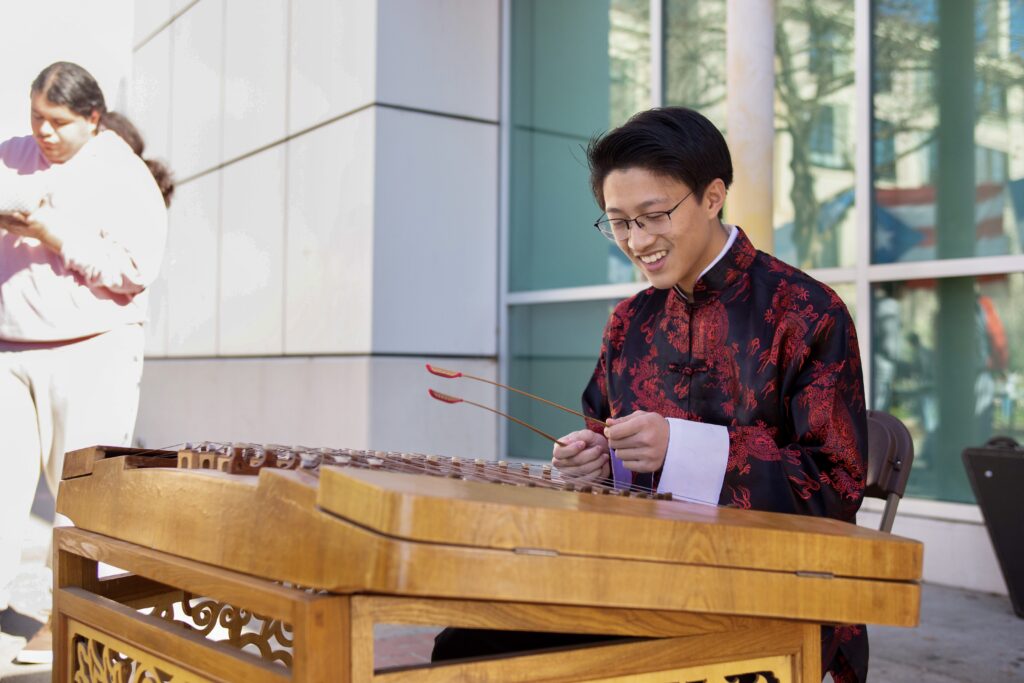 Nathan Nguyen performed the yangqin, a traditional Chinese instrument.