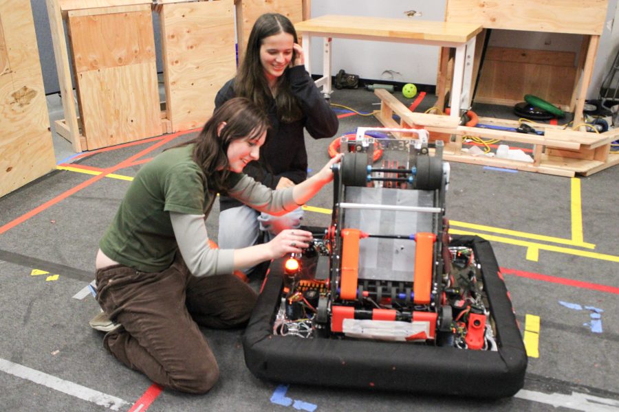 Cecelia and Avery work on a robot.