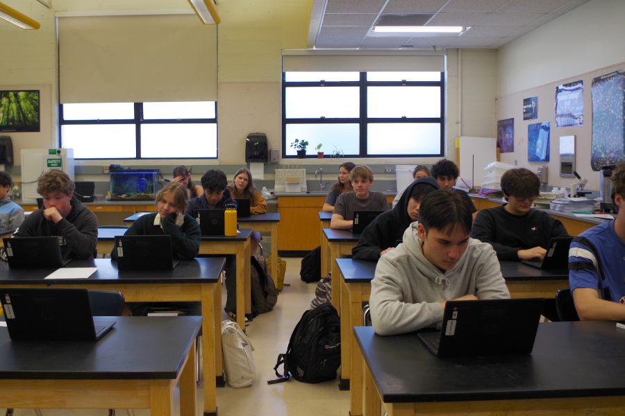Juniors in an AP Biology class take out Chromebooks to begin testing.