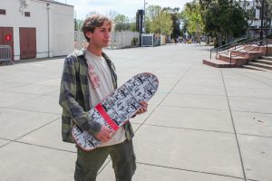 BHS junior Zael Johnson poses with his skateboard.